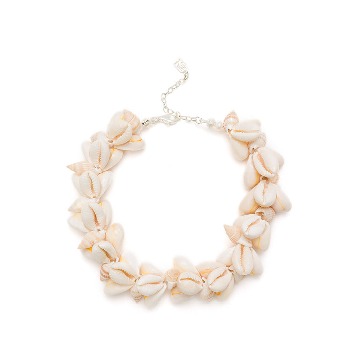 Cowrie shell and pearl anklet on a white background