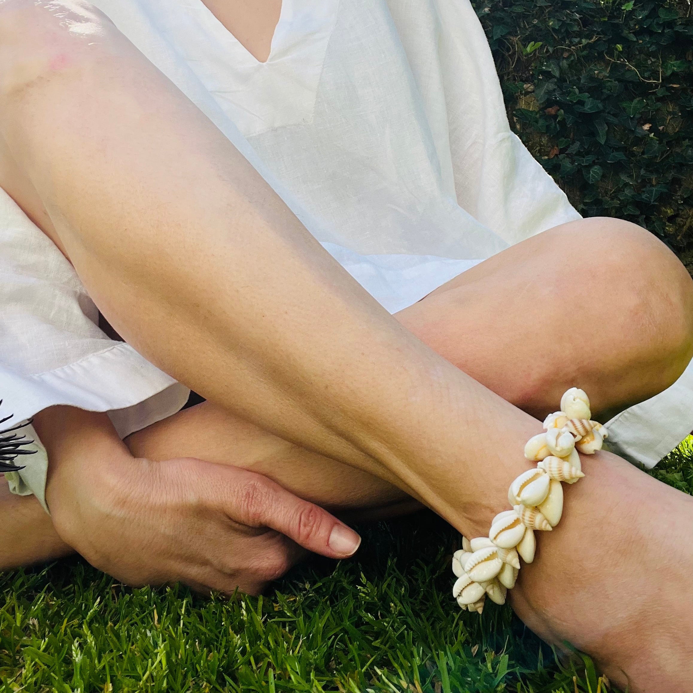 Cowrie shell and pearl anklet displayed on a model's ankle
