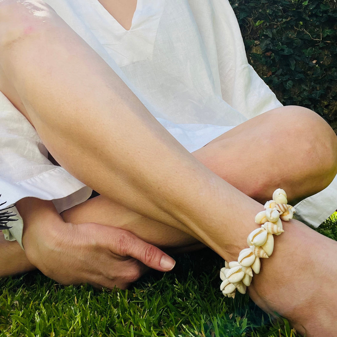 Cowrie shell and pearl anklet displayed on a model's ankle