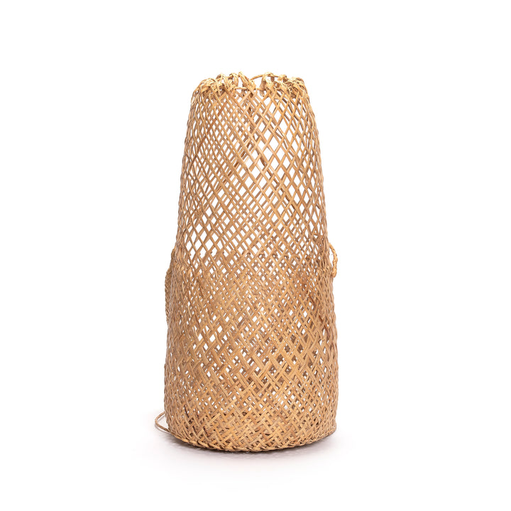 Handwoven rattan cylinder basket bag with an intricate open-weave pattern, shown on a white background.