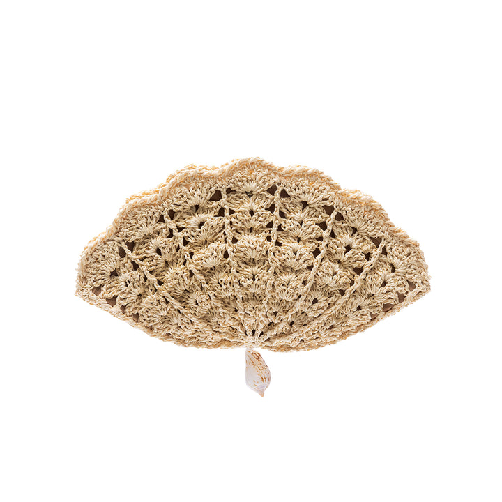 A shell-shaped natural raffia crochet clutch with an intricate lace pattern and a single hanging shell charm, displayed on a white background.