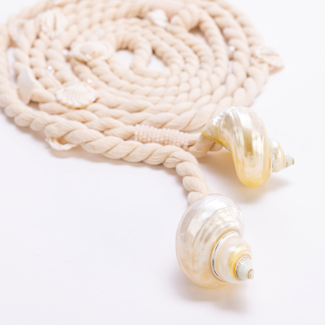 lose-up of the Turbo Belt’s hand-twisted cotton rope and polished luminous shell tassels.