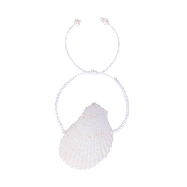 Overhead view of the handcrafted white scallop shell bracelet, highlighting the intricate braiding and the shell's organic texture.
