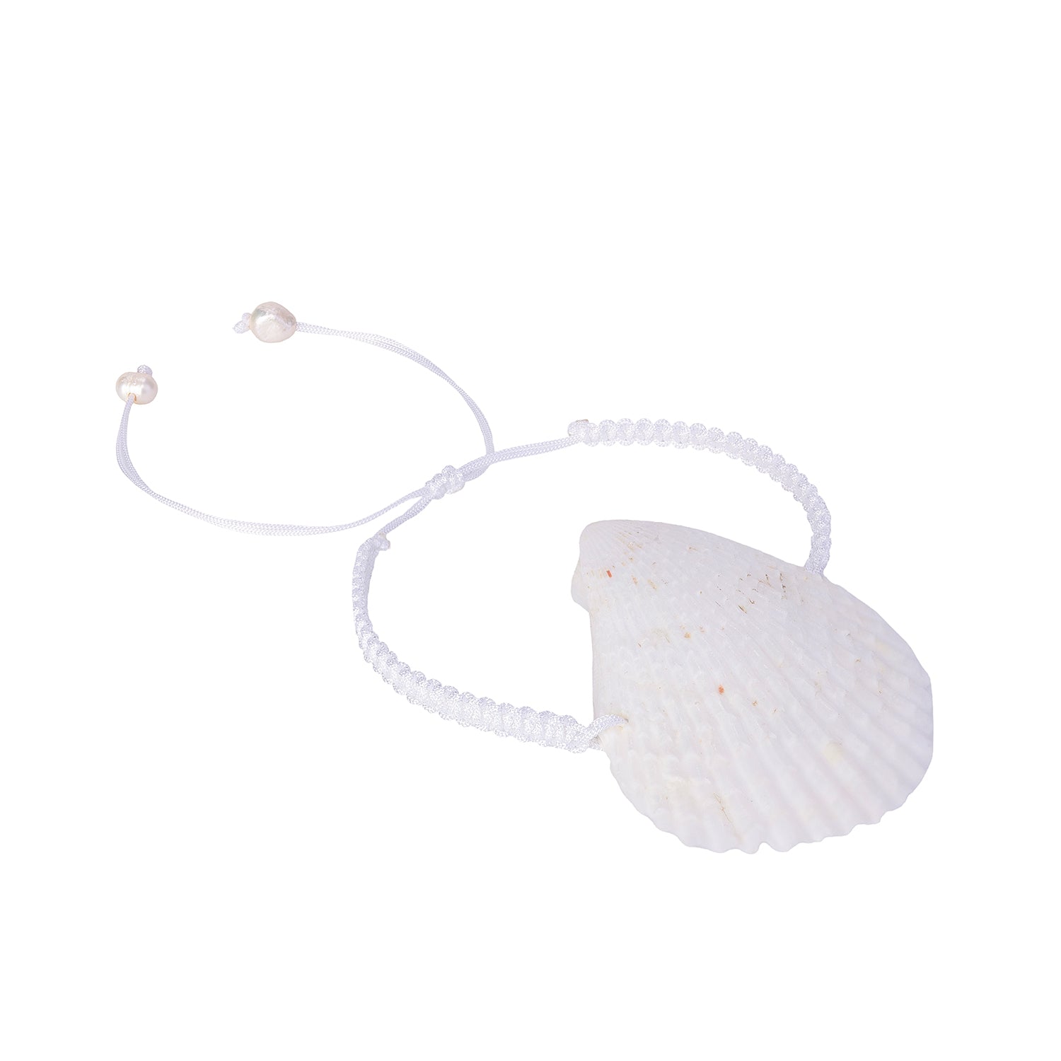 Perspective view of a white hand-braided bracelet featuring a large, natural scallop shell centerpiece and pearl-tipped adjustable ties.