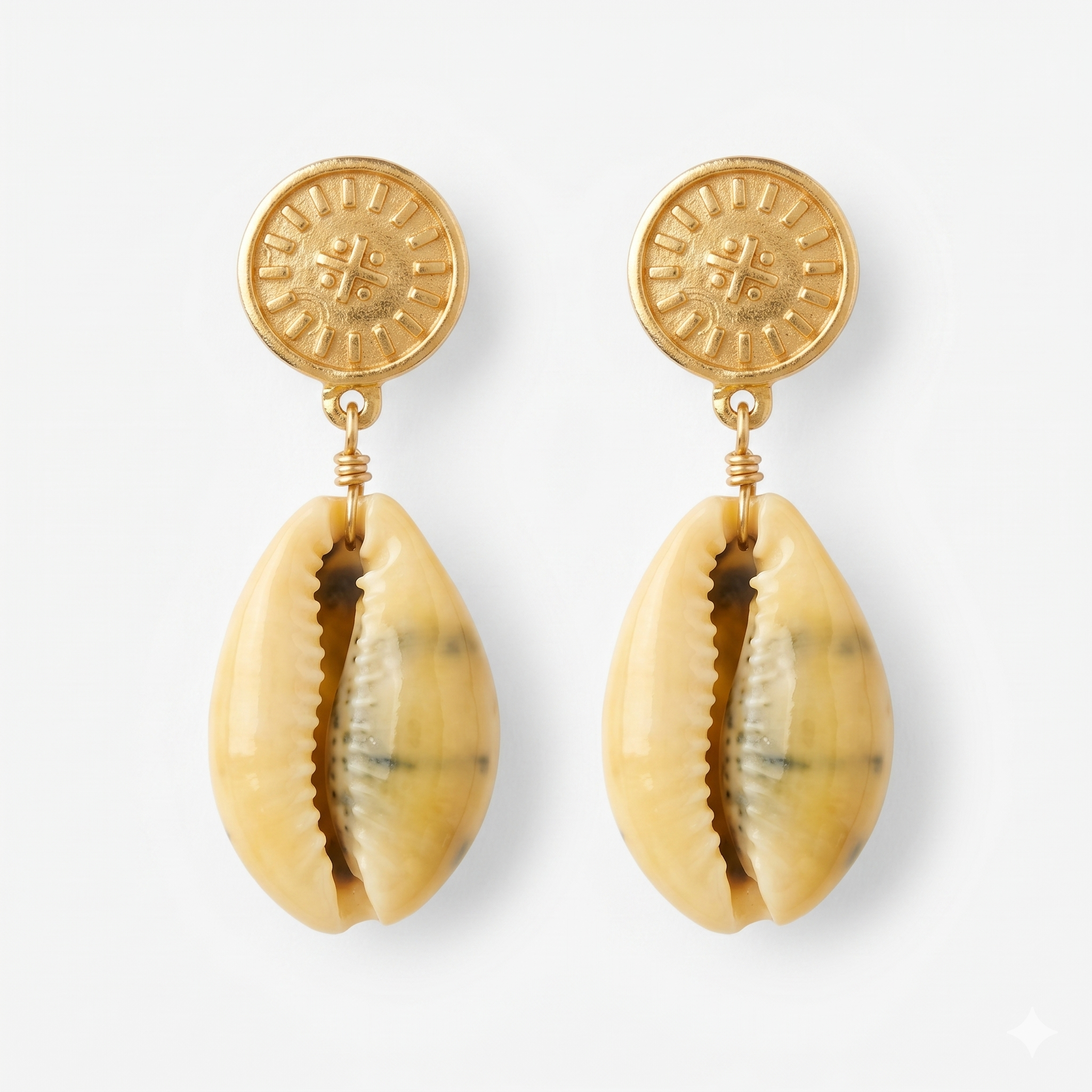 gold-plated cowrie shell earrings with a nibiru symbol