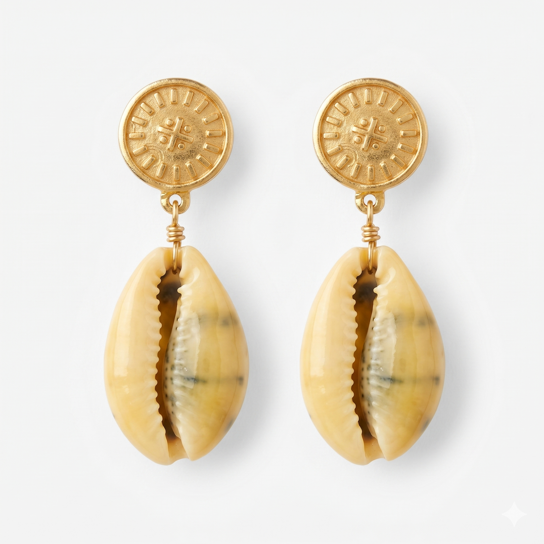 gold-plated cowrie shell earrings with a nibiru symbol