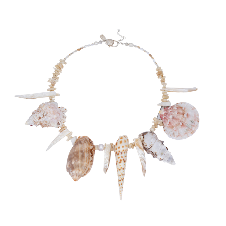 Handcrafted statement necklace featuring a curated arrangement of natural sea shells and mother-of-pearl accents.