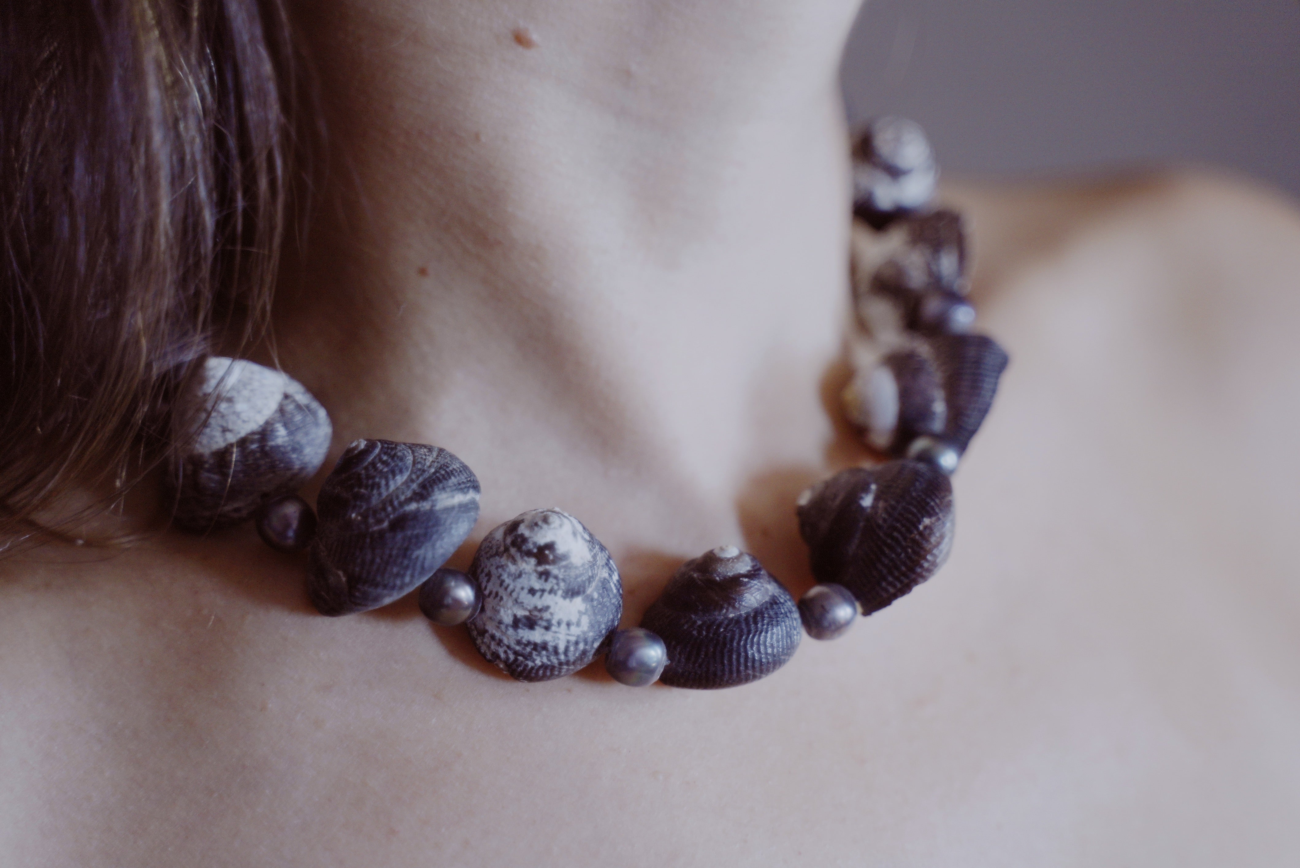 Close up of a necklace with a combination of pearlized Umbinium and black pearls.