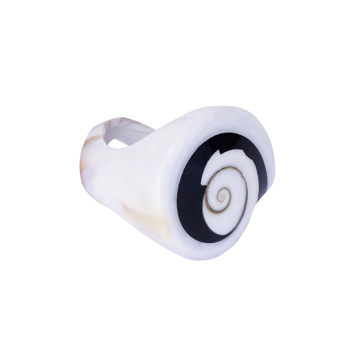 A hand-carved seashell ring with black and white colors, set with a semi-precious stone.