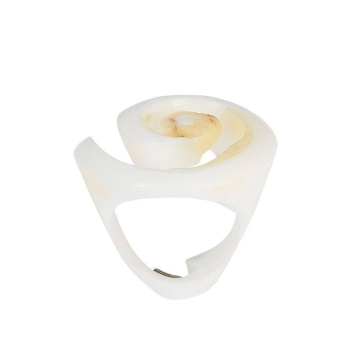 A hand-carved seashell ring made with semi-precious stones.