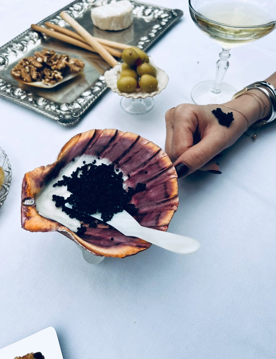 Scallop Shell-shaped serving dish filled with caviar on a dinner table