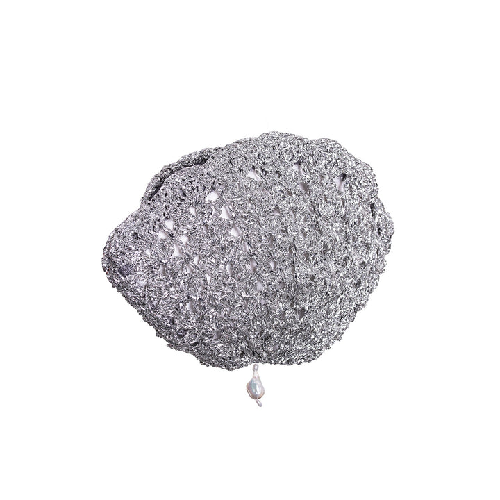 Handcrafted silver metallic crochet shell clutch featuring a pearl drop.