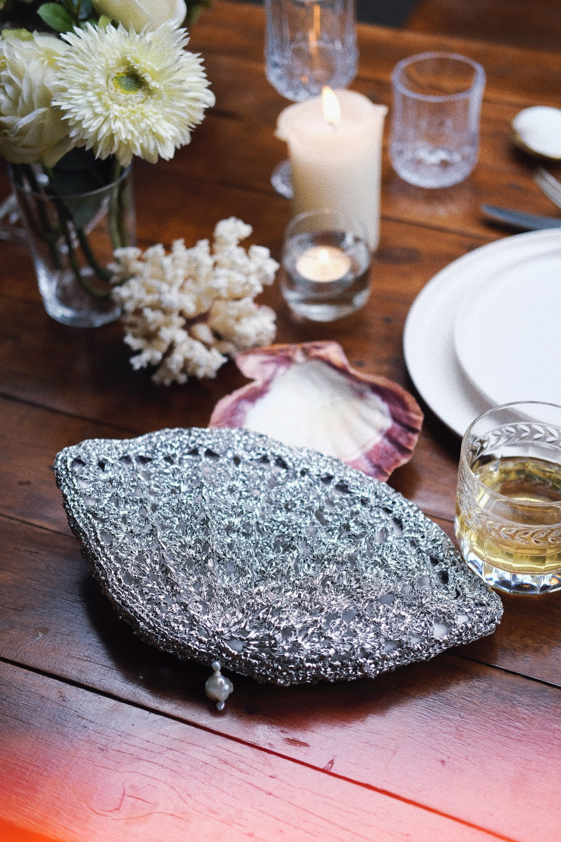 The silver shell clutch styled within an atmospheric, coastal-inspired table setting.
