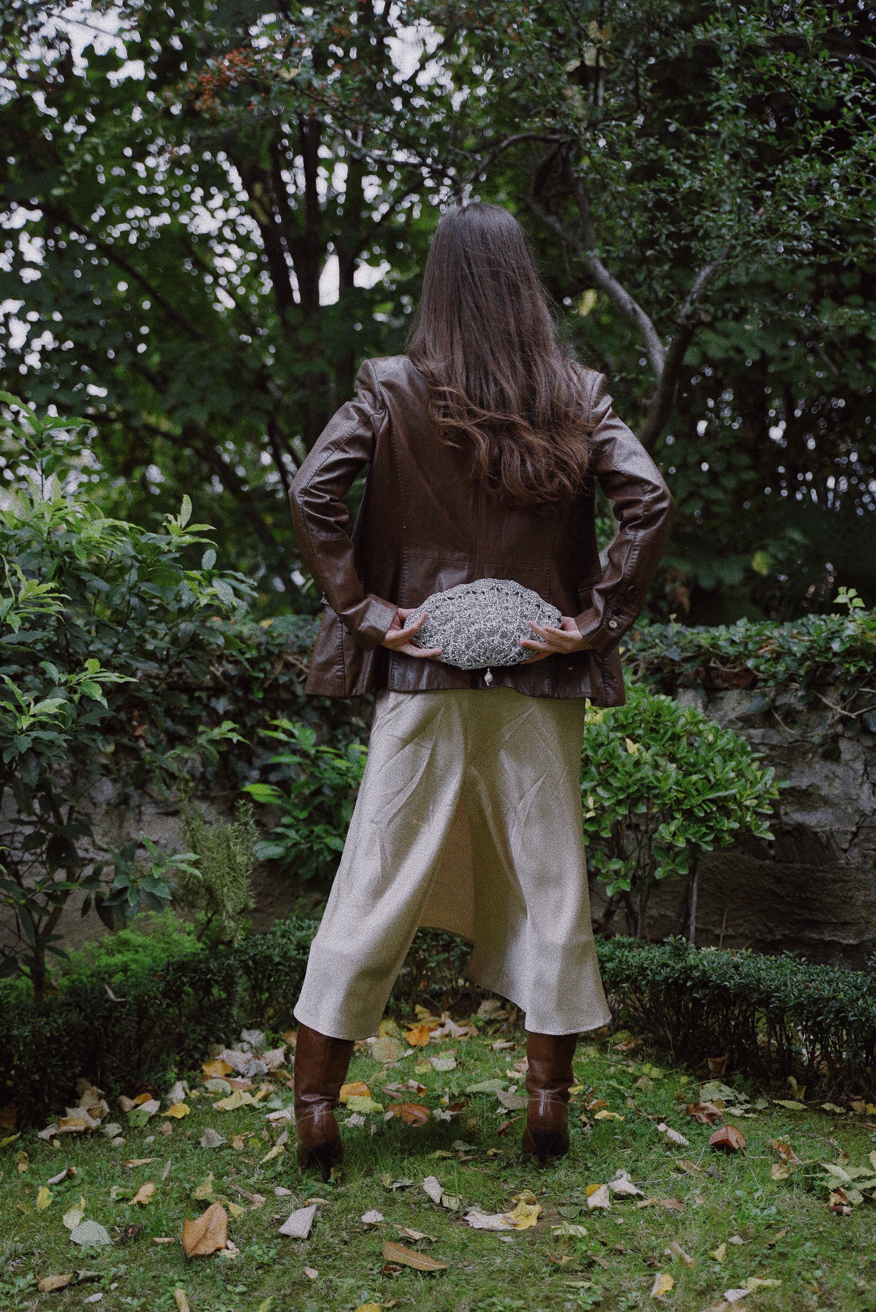 Sculptural silver shell clutch styled as a statement accessory.